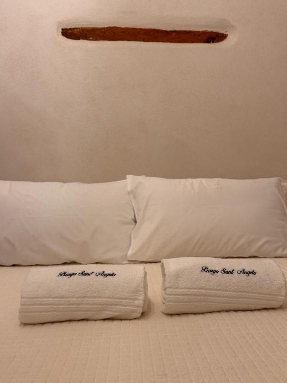 Postel nebo postele na pokoji v ubytování Borgo Sant Angelo