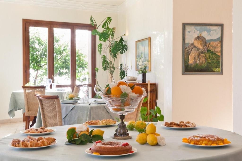 a table with a bunch of food on it at Torre Bennistra in Scopello