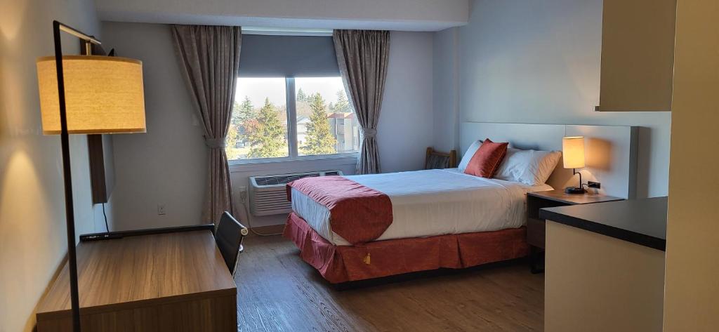 Postel nebo postele na pokoji v ubytování The Lodge Inn