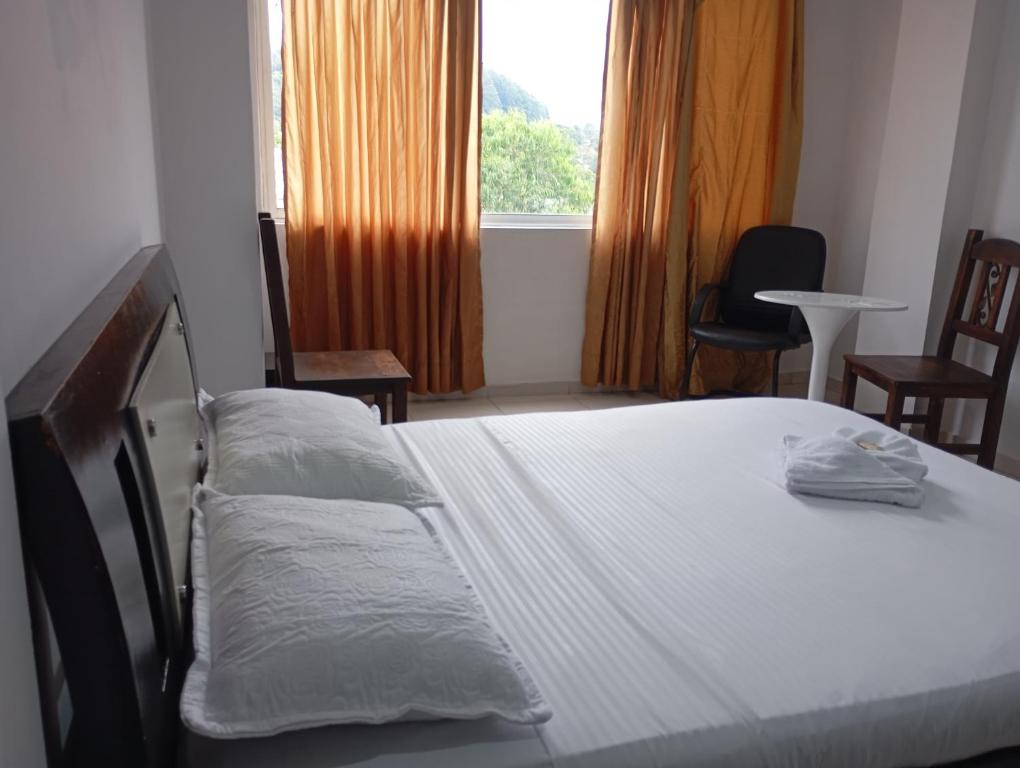 Postel nebo postele na pokoji v ubytování HOTEL MALU REAL POPAYAN Cauca