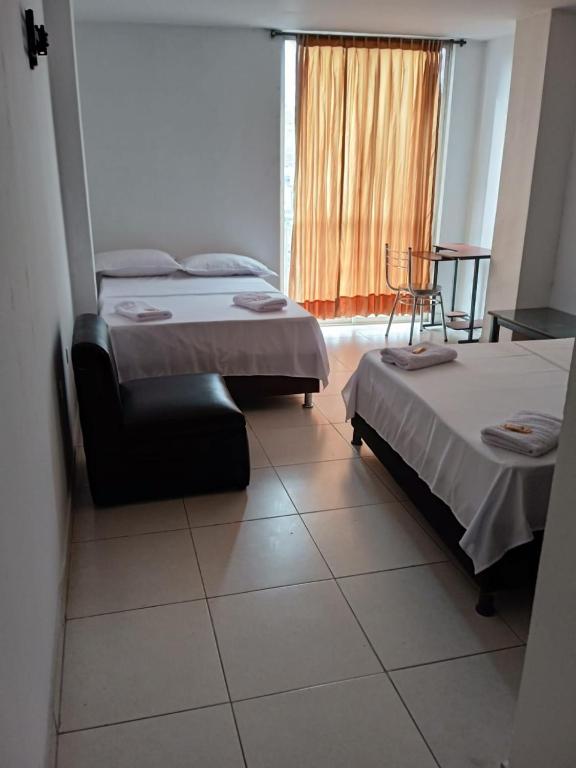 Postel nebo postele na pokoji v ubytování HOTEL MALU REAL POPAYAN Cauca