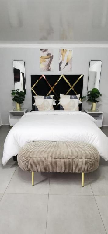 a bedroom with a large bed with a large white bedspread at Entire Self-Catering Apartment in Silverfields in Krugersdorp
