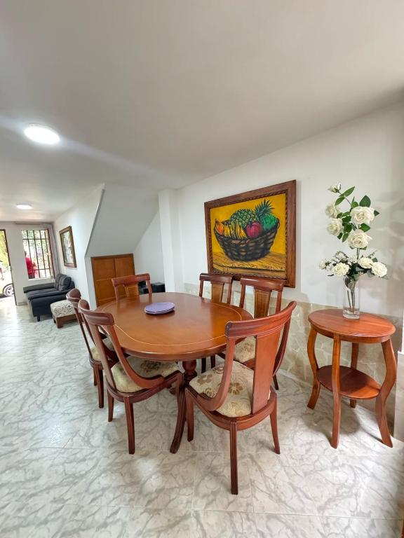 a dining room with a wooden table and chairs at Apartamento Edificio Parques Del Trianon in Envigado