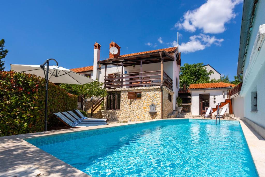 a villa with a swimming pool and a house at Villa Marak in Vrbnik
