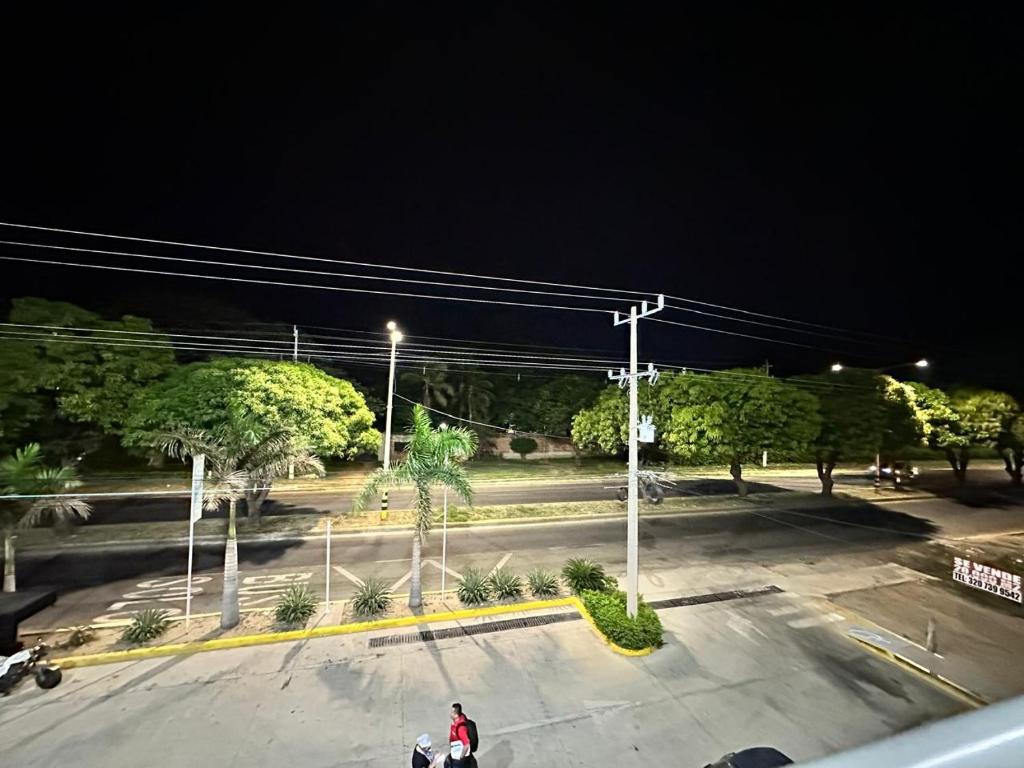 a person riding a motorcycle in a parking lot at night at Apartamento Mirador del Valle in Valledupar
