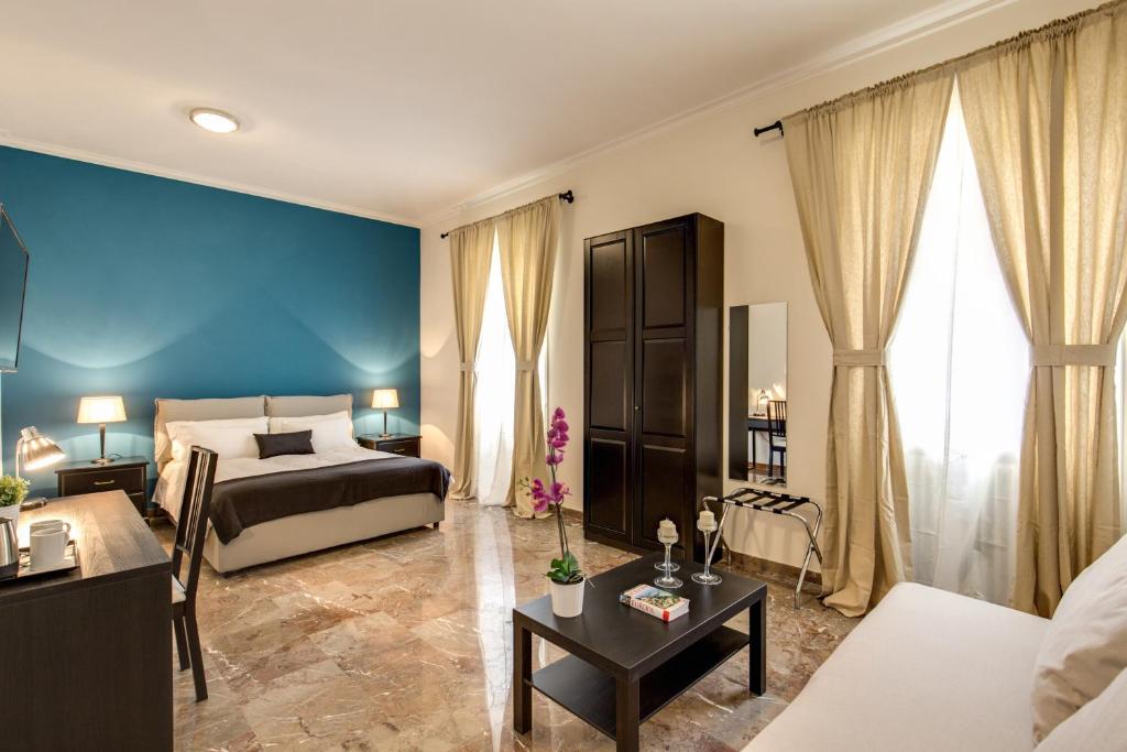 ローマにあるYH SUITE 131のベッドルーム1室(ベッド1台付)、リビングルームが備わります。