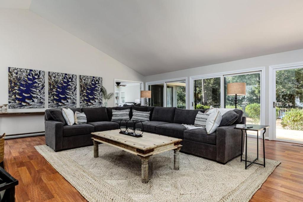 a living room with a couch and a coffee table at Turn the Page - Village of Pinehurst 3BR Getaway in Pinehurst