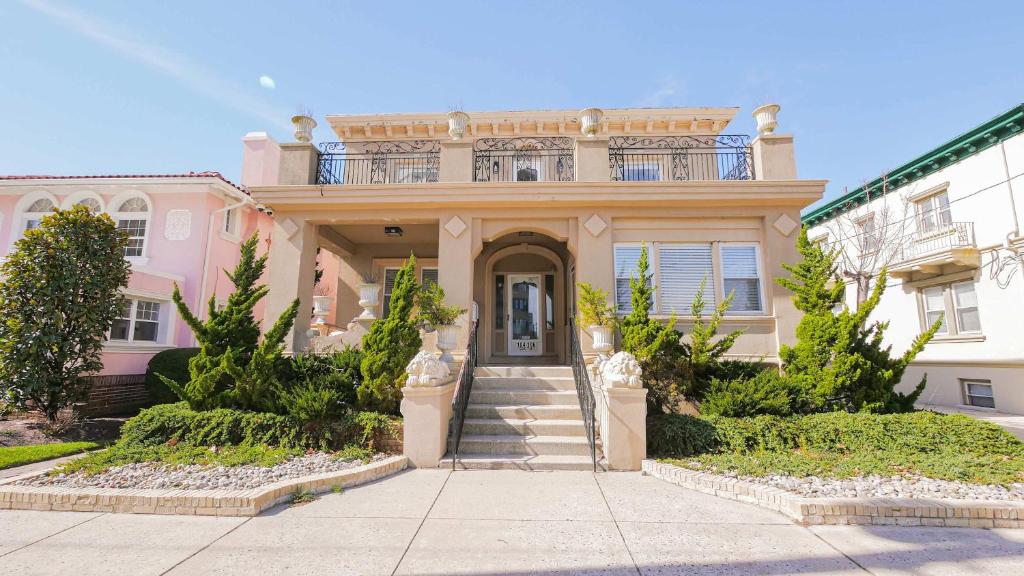 a pink house with a balcony on top of it at 4BR 2BA Luxe Beach Estate II in Atlantic City