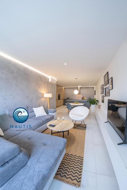 a living room with a couch and a table at Apartmán NAUTIS in Piešťany