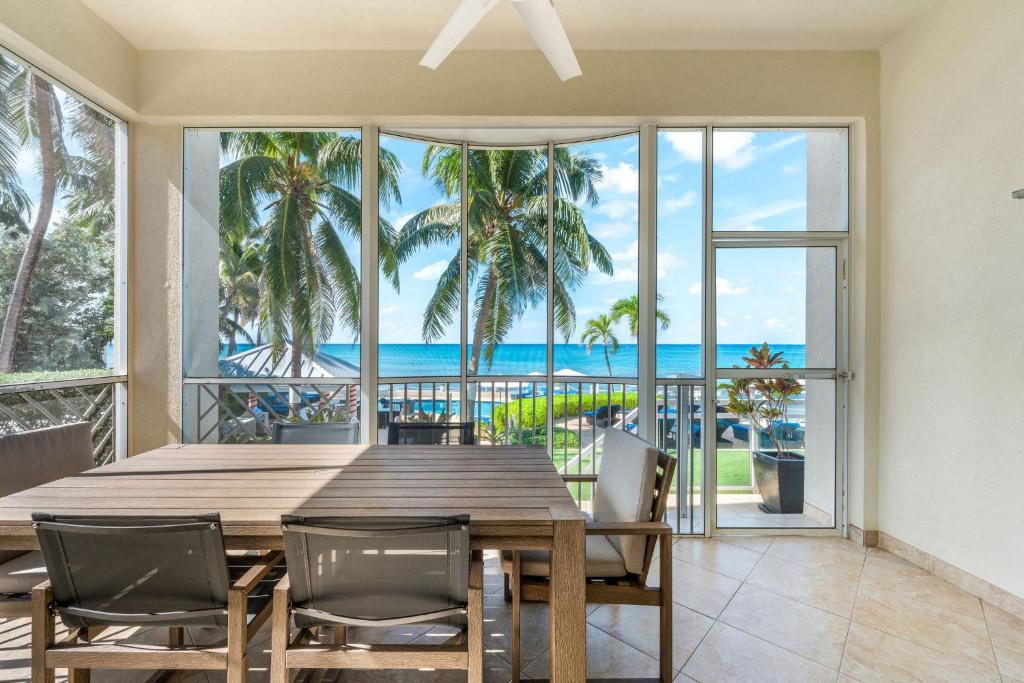 - une salle à manger avec une table et des chaises et une vue sur l'océan dans l'établissement South Bay Beach Club #1 - 2 Bedroom 2 Bathroom Unit, à Dog City