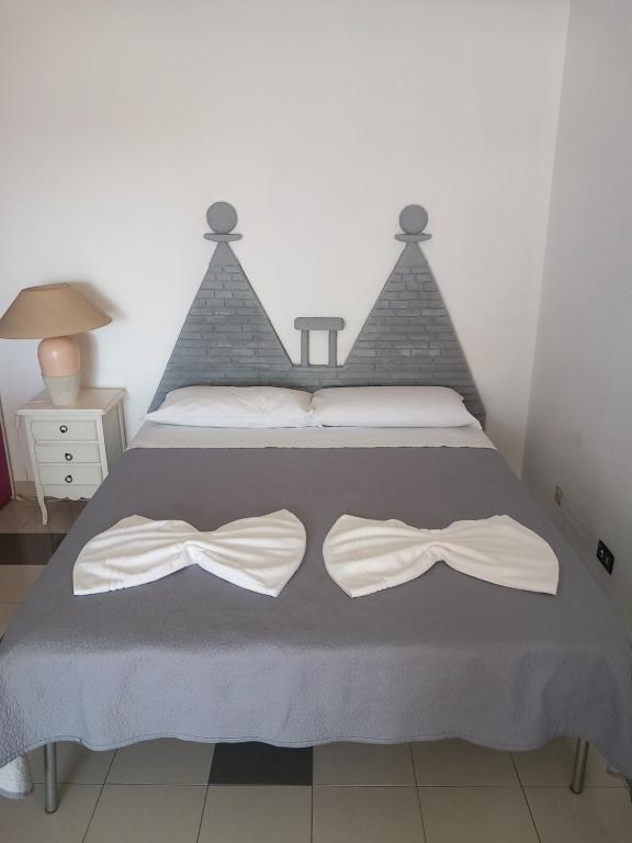 a bedroom with a bed with two bows on it at Antica Puglia 3 in Alberobello