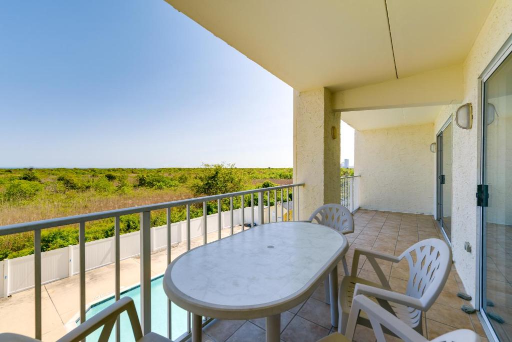 a patio with a table and chairs on a balcony at Atlantic City Area Vacation Rental with Pool Access! in Brigantine