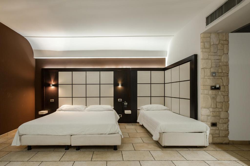 Postel nebo postele na pokoji v ubytování Hotel Testani Frosinone