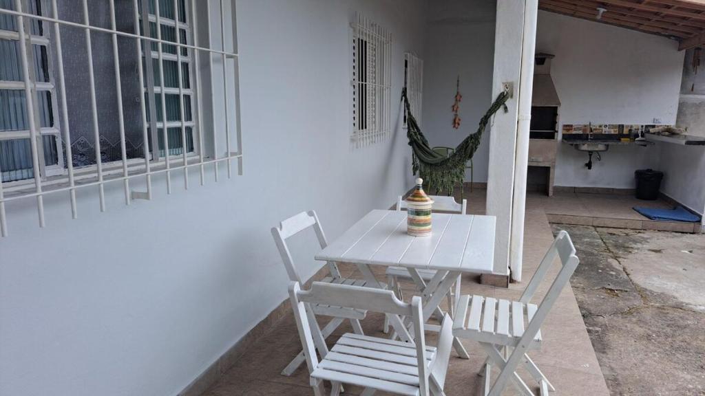 a white table and chairs on a patio at Refúgio próximo as praias de Massaguaçu e Mococa in Caraguatatuba