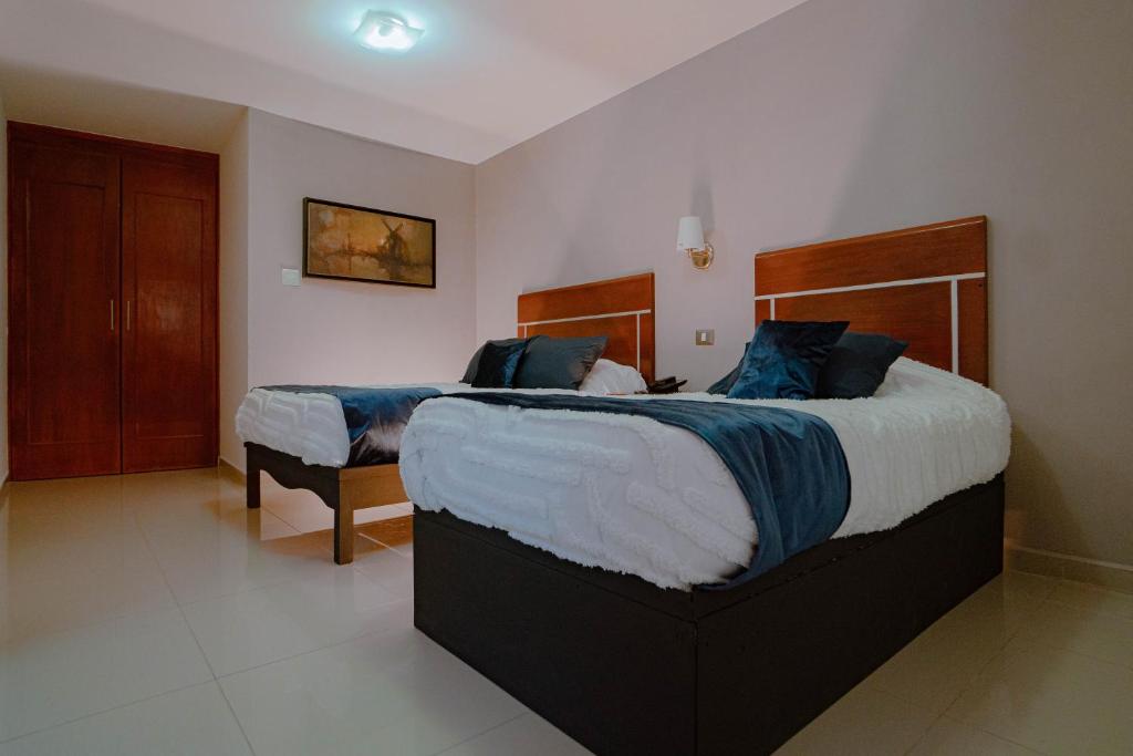 Postel nebo postele na pokoji v ubytování Hotel Quirasco