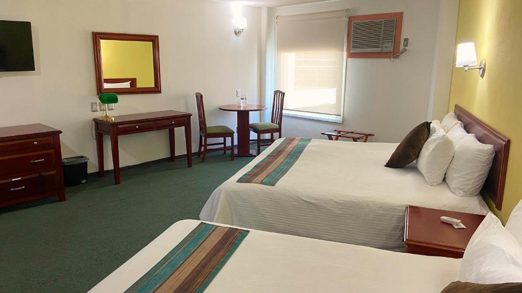 Postel nebo postele na pokoji v ubytování Hotel Enterprise Inn Poliforum