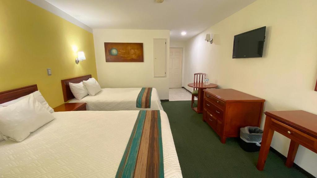 Postel nebo postele na pokoji v ubytování Hotel Enterprise Inn Poliforum
