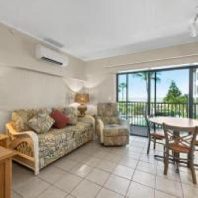 a living room with a couch and a table at Caribbean Beach Club in Fort Myers Beach