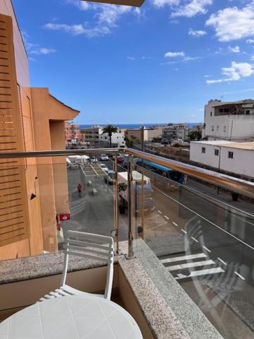 a balcony with a chair and a view of a city at Arminda in Arguineguín