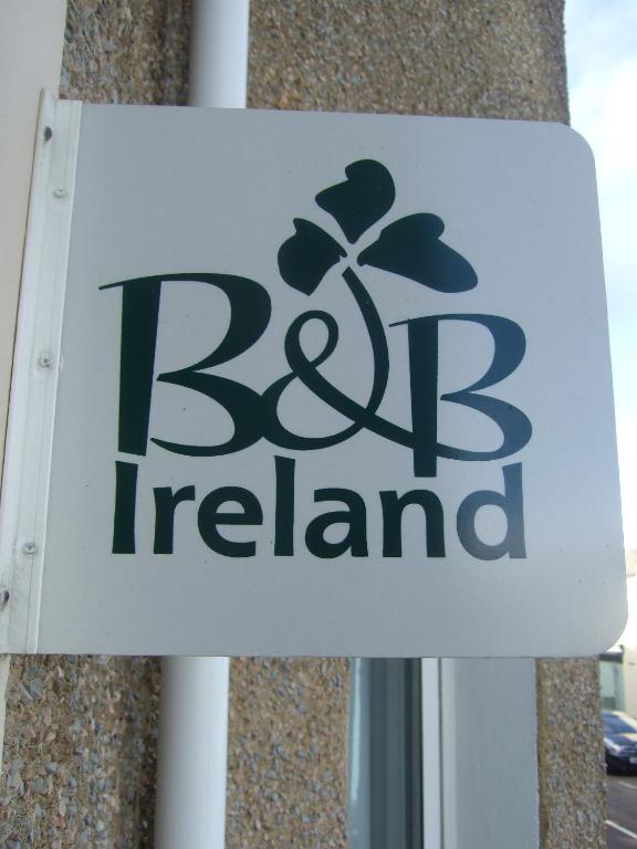 a sign for a berg island store at Beulah Guest House in Portrush