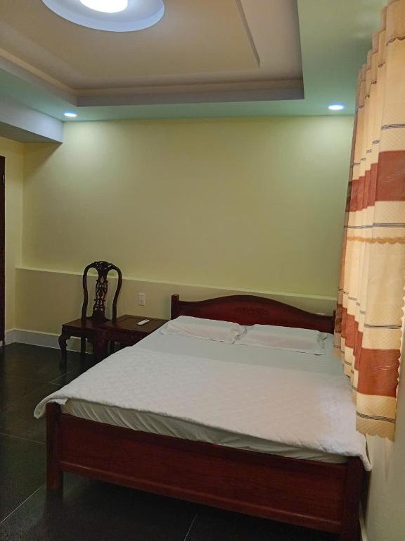 Postel nebo postele na pokoji v ubytování HOTEL MOTeL ĐỒNG KHỞI