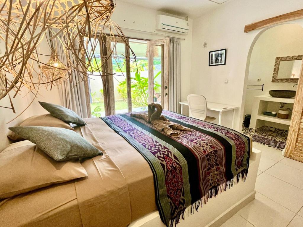 a bedroom with a bed with a stuffed animal on it at Pura Vida in Uluwatu