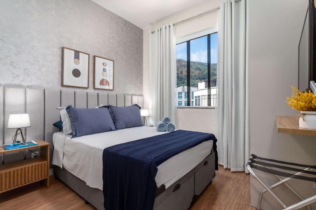 Hotel Copacabana Beach Prado Loft, a bedroom with a large bed and a large window at Copacabana Beach Prado Loft in Rio de Janeiro