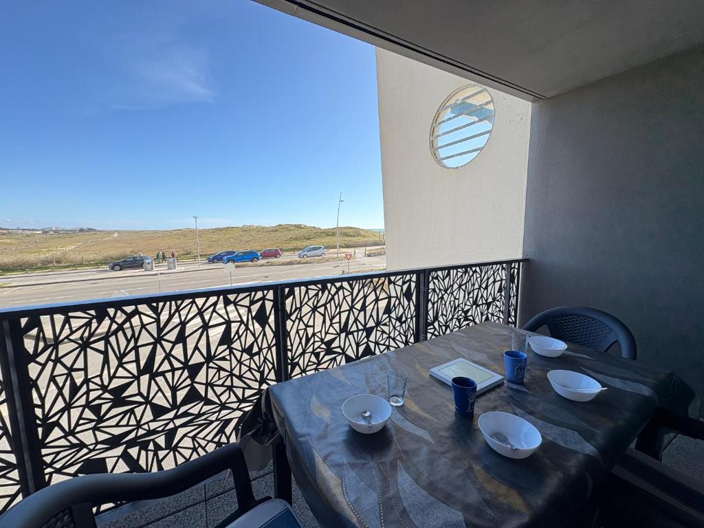d'une table sur un balcon avec vue sur l'autoroute. dans l'établissement Appartement cosy avec vue mer, parking privé, 2 chambres - FR-1-323-569, à Saint-Hilaire-de-Riez