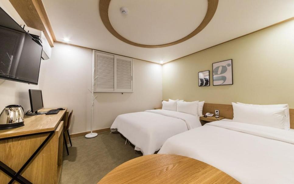 Postel nebo postele na pokoji v ubytování XYM Hotel