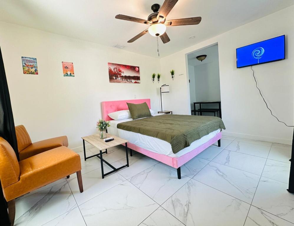 a bedroom with a bed and a chair at Spacious Studio heart Of Miami in Miami