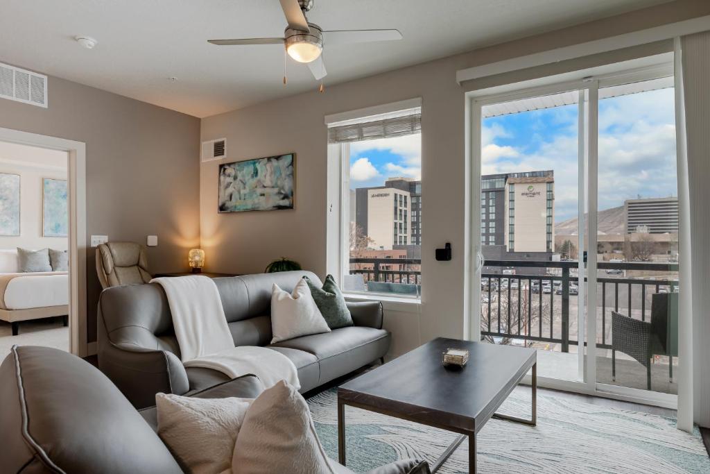 a living room with a couch and a table at Convention Ctr Lux 2BR Pool,Htub,Gym,Theatre,Pkg in Salt Lake City