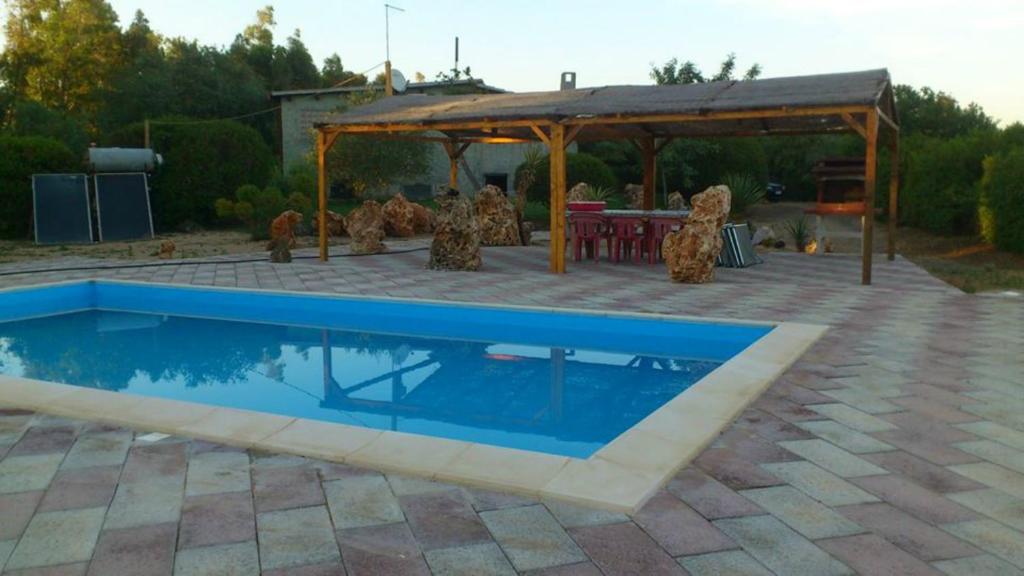 a swimming pool in a patio with a gazebo at Villa Angioj in Tottubella