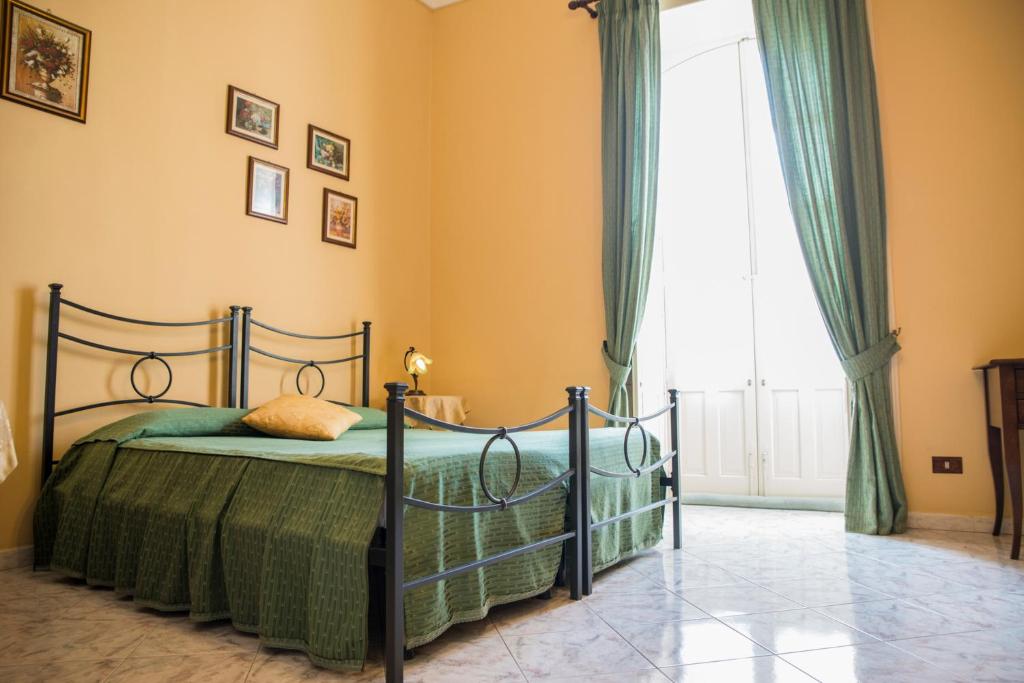 Postel nebo postele na pokoji v ubytování Sognando Ortigia