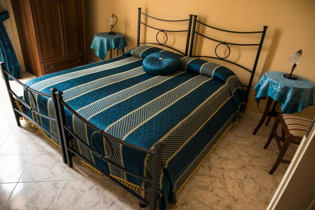 Postel nebo postele na pokoji v ubytování Sognando Ortigia