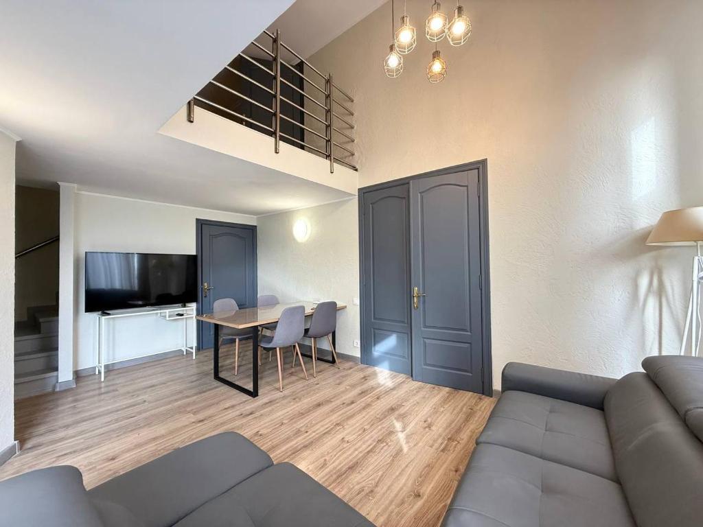 a living room with a couch and a table at 18 Deribasivska Street Jacuzzi Apartment in Odesa