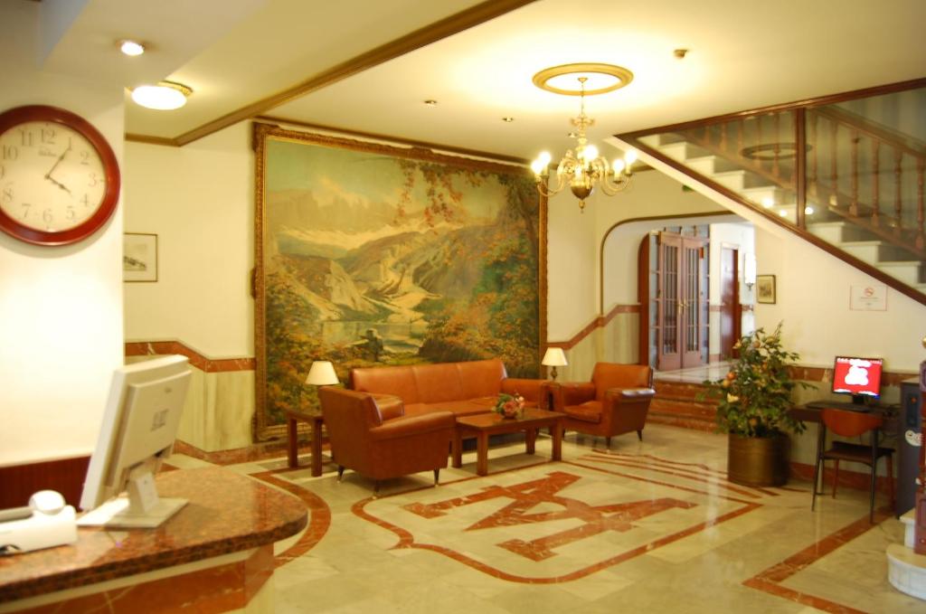 a living room with a large painting on the wall at Hotel Marina Victoria in Algeciras