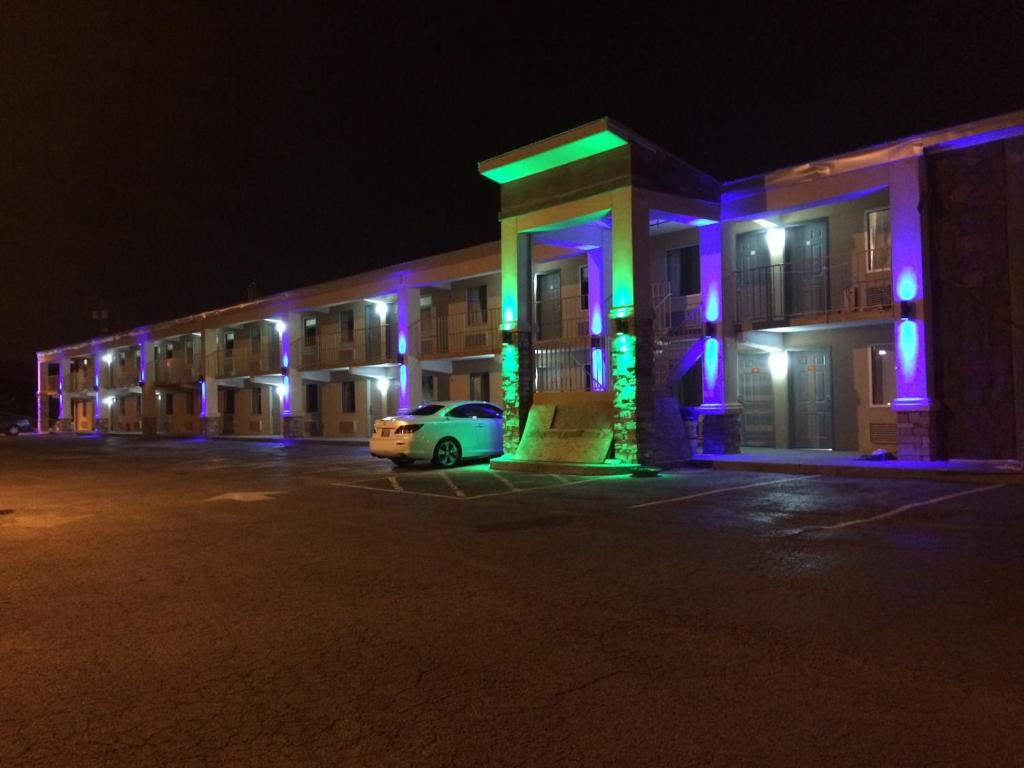 a car parked in front of a building at night at Lotus Inn and Suites Nashville in Nashville