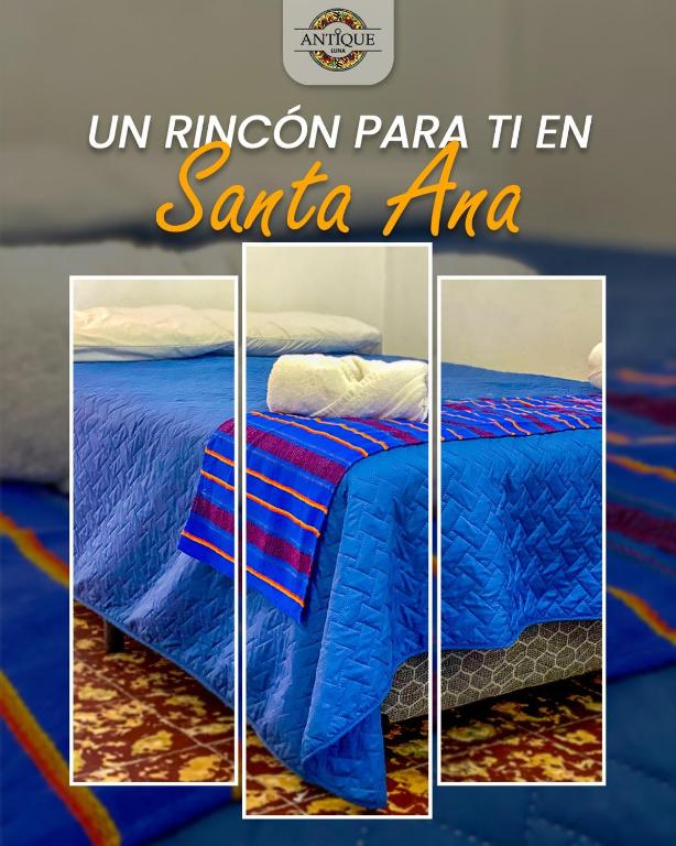 a picture of a bed with a blue comforter at Hostal Antique Luna in Santa Ana