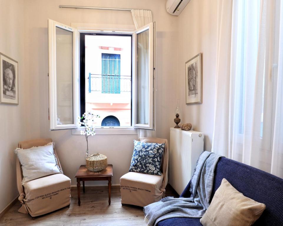 a living room with a blue couch and a window at La Casa Buranella in Lefkada