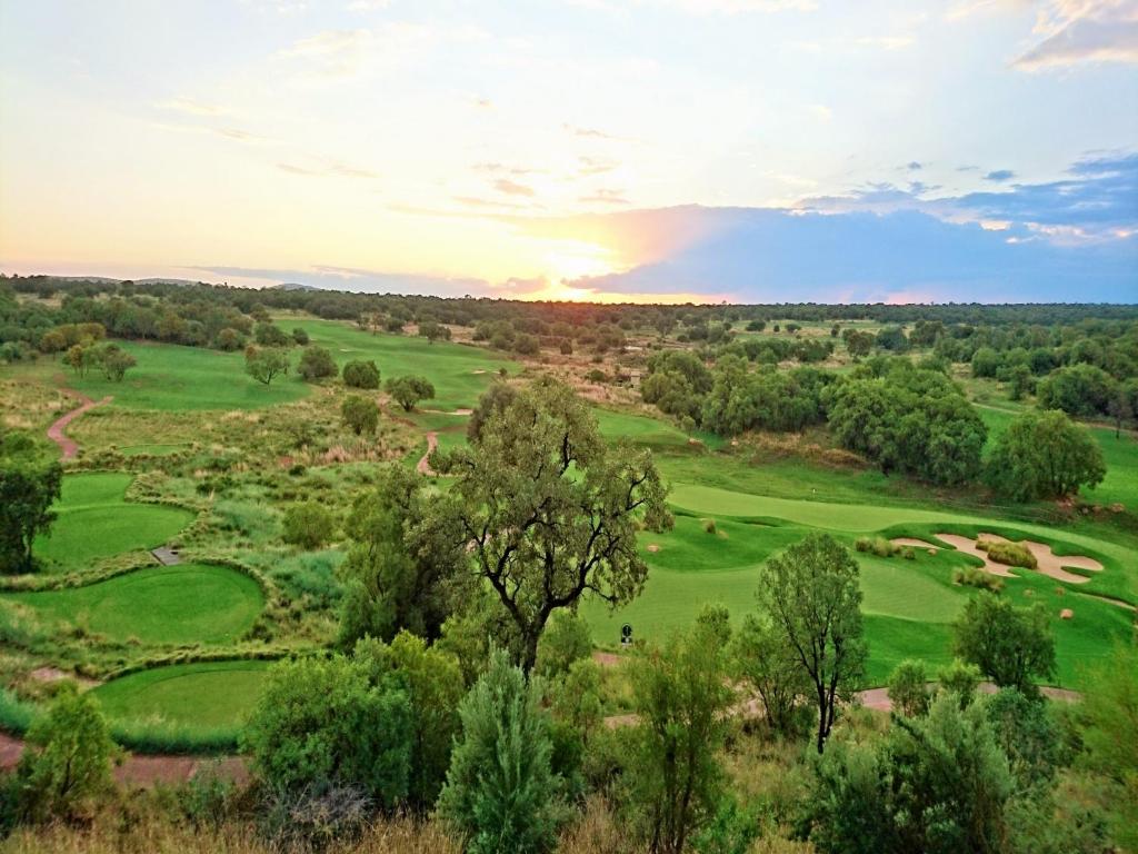 an aerial view of a golf course with a sunset at Elements Private Golf Reserve in Bela-Bela