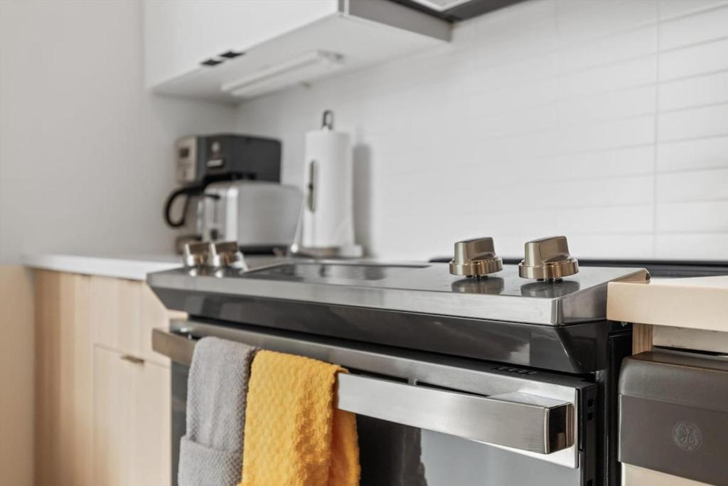 a kitchen with a stove with towels on it at NoMa Convenience 2-BR Near Metro Union Market in Washington, D.C.