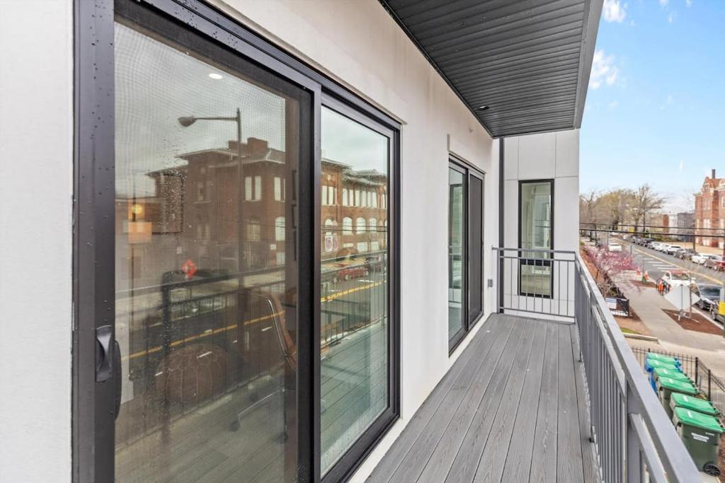 a balcony with large windows and a view of a city at NoMa Convenience 2-BR Near Metro Union Market in Washington, D.C.