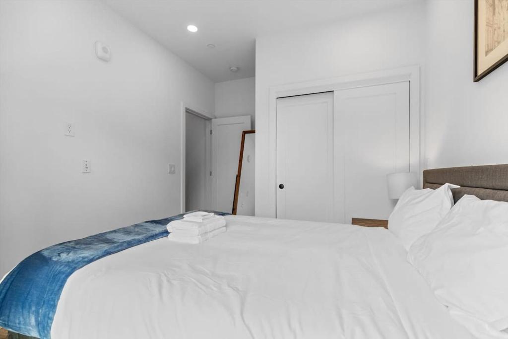 a bedroom with a white bed with towels on it at NoMa Convenience 2-BR Near Metro Union Market in Washington, D.C.