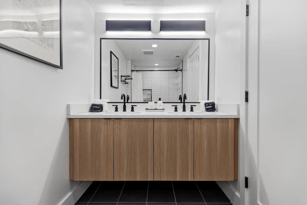 a bathroom with a sink and a mirror at NoMa Convenience 2-BR Near Metro Union Market in Washington, D.C.