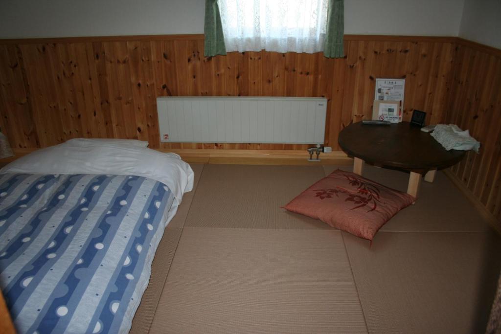 Postel nebo postele na pokoji v ubytování Pension Jokura