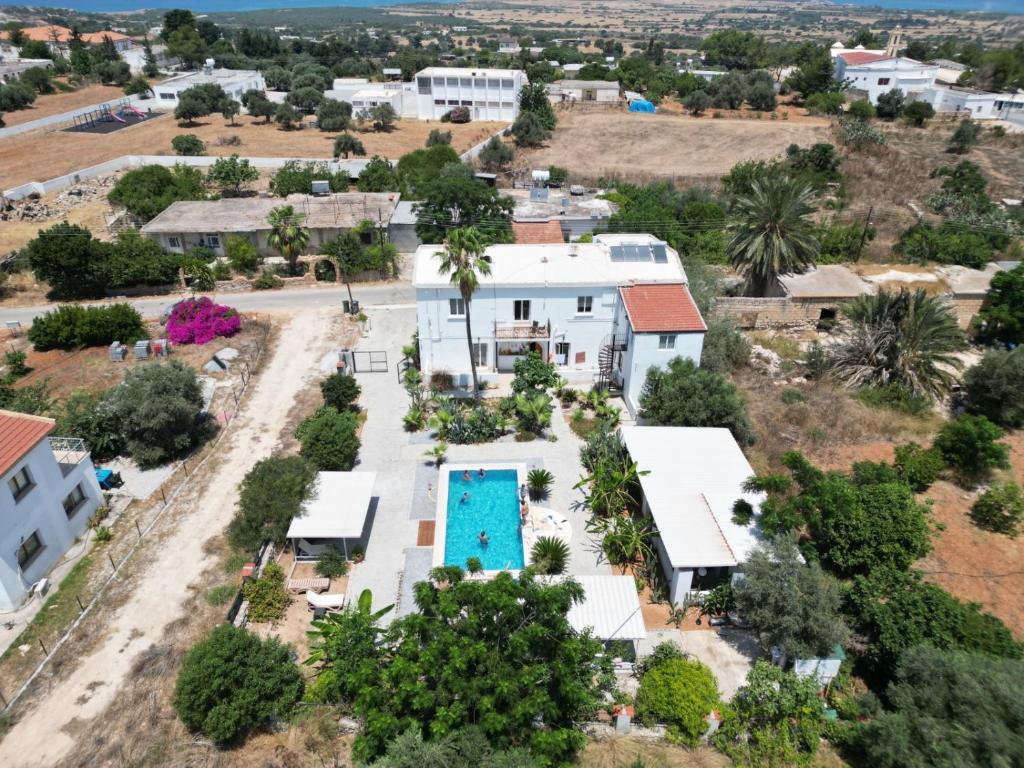 an aerial view of a house with a swimming pool at Hera palace boutique otel in Yialousa
