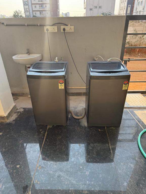 a bathroom with a toilet and a sink at COCO NET Hotel in Ibrāhīmpatan