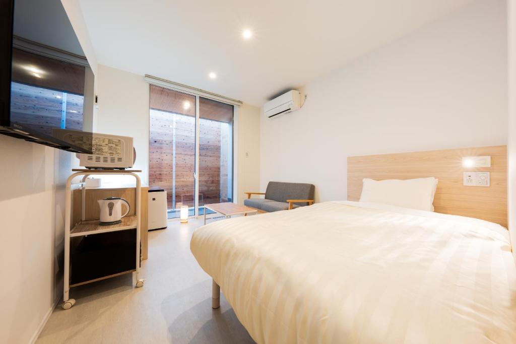Postel nebo postele na pokoji v ubytování Hotel Meguri