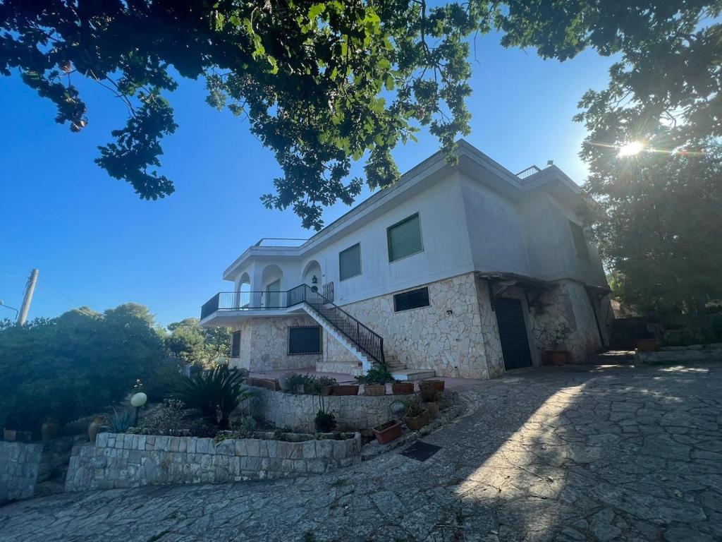 a large white building with a balcony on top at Villa Ubertina - Tricase Porto in Marina Porto