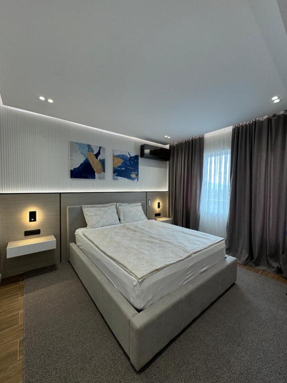 a large bedroom with a large white bed in it at Sliv in Vinica